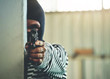 © Fluky - Thieves used a gun battle in the corner of the building.Focus on hand and gun