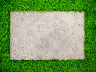 Square concrete plate on artificial green grass background