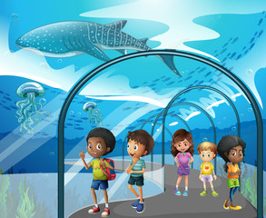 Wall Mural - Children looking at fish in aquarium