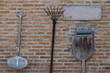 Spade and Shovel placed on a brick wall