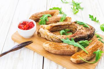 Grilled fish tilapia and chili plantains with arugula