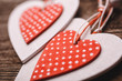 White and red sewed christmas hearts on wooden background