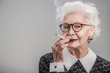 © Yakobchuk Olena - Happy aged lady enjoying ciggy