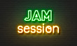 Jam session neon sign on brick wall background.