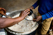 © sadokhinstas - lunch at african school. Hands of woman while feed a children with porridge and beans