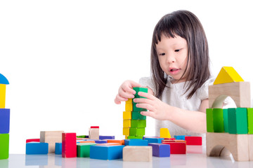 Wall Mural - Little asian girl playing wood blocks over white background