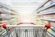 © nonnie192 - Supermarket aisle with empty red shopping cart