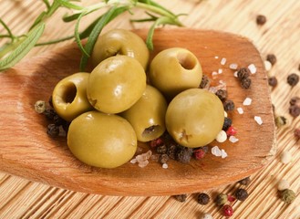 Wall Mural - green olives on a wooden background