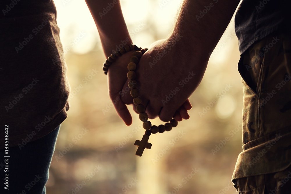Holding rosary in hand. - obrazy, fototapety, plakaty 