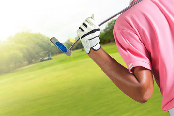 Wall Mural - Golf player holding a golf club in golf course