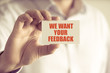 © stanciuc - Businessman holding WE WANT YOUR FEEDBACK message card