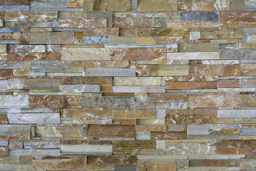 Pattern of Natural stone pieces tiles for walls,orange slate wall texture and background,Template mock up for display of your product.selective focus