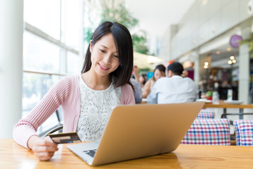 Wall Mural - Woman using laptop computer to pay the bill online