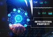 © Egor - Business, Technology, Internet and network concept. Young businessman working on a virtual screen of the future and sees the inscription: Intellectual property