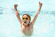 Excited little boy having fun in swimming pool
