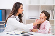 © inesbazdar - Female doctor examine throat of a child at the medical office.