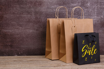 Mockup of blank shopping bags. Sale discounts. Brown and black craft packages. Concept for sales or discounts. Recycled paper.