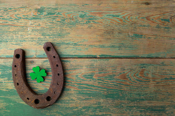 Wall Mural - St. Patricks day, lucky charms. Horesechoe and shamrock on wooden background