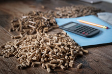 Calculating Household Heating Costs. Wooden Pellets, Biomass, Effective, Environmentally Friendly And Economical Heating, Sustainable And Renewable Energy