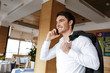 © Drobot Dean - Side view of man in restaurant talking on phone