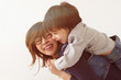 © Viktor Koldunov - Japanese mother hugs her son, they laugh and smile. Warm family relations.