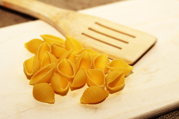 Wooden spatula and different pasta