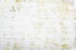 White grunge wall with gold layer in the backround