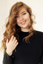 Young Attractive Girl Smiling With Dimples And Curls Of Blond Ha