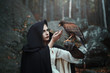 Black hooded huntress with hawk