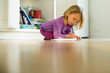 © Sarah Rypma - Preschool girl on floor drawing in drawing pad