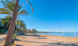 Ibiza sun shines of the beach in Sant Antoni de Portmany,  Take a walk along main boardwalk or in the sand.   November beach in warm morning sunshine. 