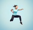 © Syda Productions - happy sporty young woman jumping in fighting pose