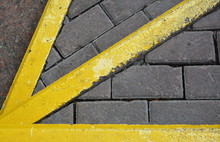 Yellow Arrow Pointer To The Pavement.