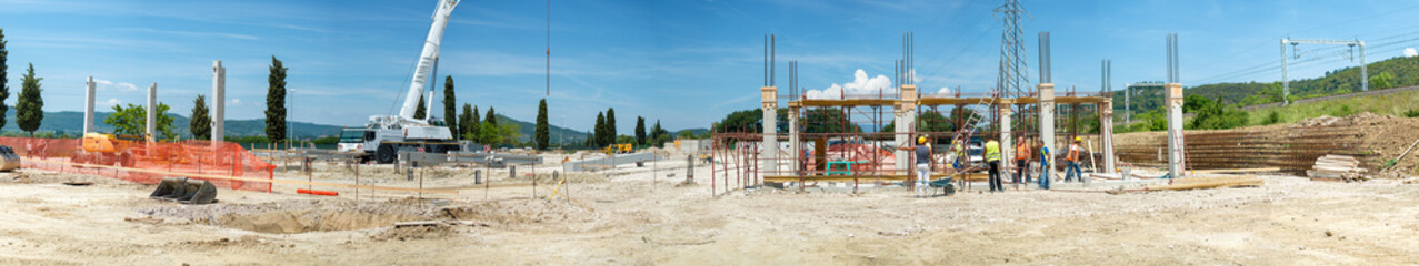 Landscape transformation into urban area with machinery, people working. View on construction site