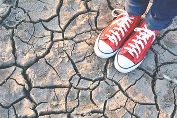 sneaker on crack dry ground, concept drought