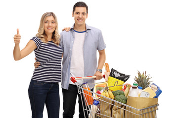 Canvas Print - Woman giving thumb up and man with shopping cart