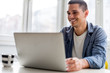 © Stock Rocket - Smiling man in front of computer