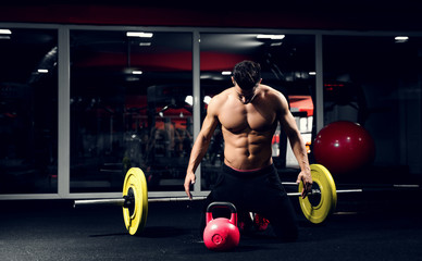 Body builder gym preparing for workout. Weightlifter kettle bell.