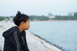 © Rewat Patisena - Asian girl looking down to the right