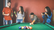 Young friends talking and playing pool at billiard table saloon - Happy friendship concept with fashion people having fun together and drinking beer at snooker gameroom - Vintage retro contrast filter
