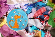 Ceramic Handmade Blue Plate With Funny Orange Dog On Variety Of Multi-colored Pieces Of Fabric