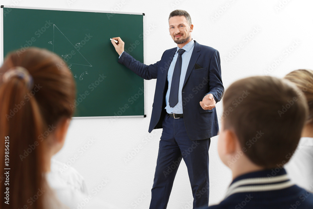 Male teacher conducting lesson in classroom