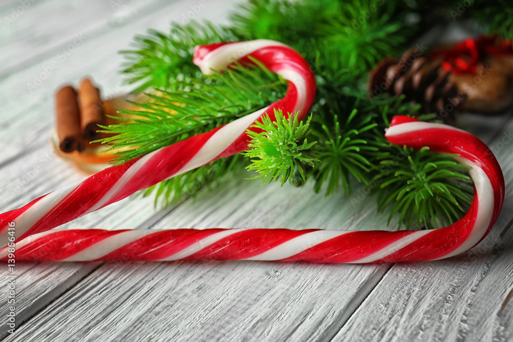 Christmas candy canes on wooden table closeup