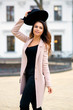 © Александр Беспалый - The girl in a coat with black hat on head.