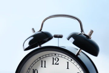 Wall Mural - Alarm clock on light background, closeup