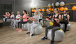© Africa Studio - People of different ages training with fit balls in gym