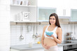 © Africa Studio - Beautiful pregnant woman in kitchen