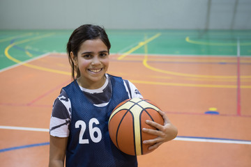 Mixed race girl holding basketball