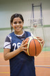 © Dmytro Surkov - Girl standing with ball in basketball court