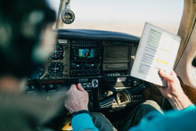 Flight Instructor And Student Reviewing Flight Checklist